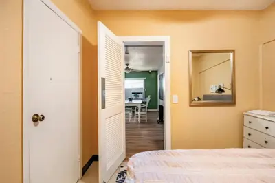 a bedroom with a bed and a dining room at 3-Bed Bungalow walk to Historic Downtown Sanford in Sanford