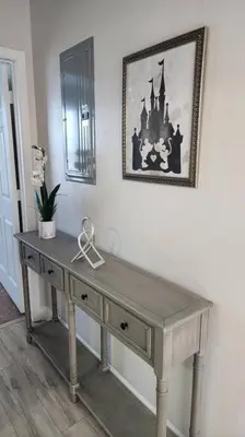 a wooden table in a room with a picture on the wall at Apartment Kissimmee - Orlando in Kissimmee