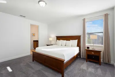 a bedroom with a large bed and a window at Delightful Home Near Disney With Private Pool And Waterpark & Resort Access At Encore Resorts Reunion - 441No in Kissimmee