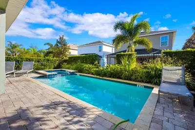 a swimming pool in the backyard of a house at Delightful Home Near Disney With Private Pool And Waterpark & Resort Access At Encore Resorts Reunion - 441No in Kissimmee