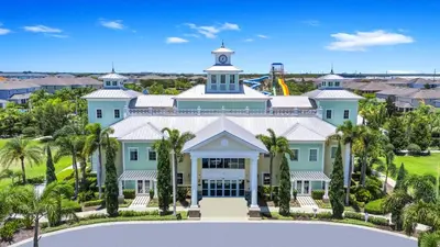 an aerial view of a large house with palm trees at Delightful Home Near Disney With Private Pool And Waterpark & Resort Access At Encore Resorts Reunion - 441No in Kissimmee