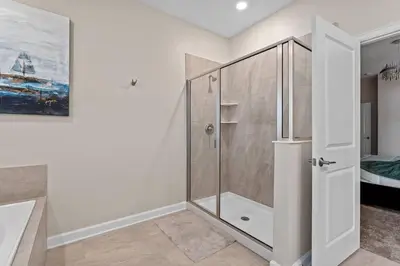 a shower with a glass door in a bathroom at 7 BR Large Pool Game Room @ Storey Lake SL2861 in Kissimmee