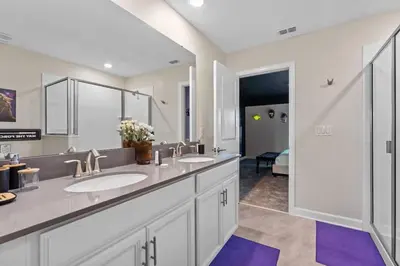 a bathroom with two sinks and a large mirror at 7 BR Large Pool Game Room @ Storey Lake SL2861 in Kissimmee