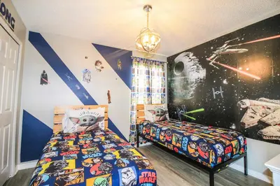 a bedroom with two beds and a star wars wall at Emerald Island Escape- Pool and spa in Kissimmee