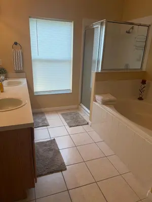 a bathroom with a tub and a sink at Luxury 5 Bedroom Villa with Secluded Pool/Spa in Glenbrook community near Orlando in Orlando