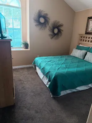 a bedroom with a bed with eyes on the wall at Luxury 5 Bedroom Villa with Secluded Pool/Spa in Glenbrook community near Orlando in Orlando