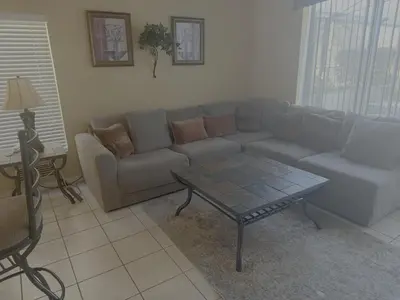 a living room with a couch and a coffee table at Luxury 5 Bedroom Villa with Secluded Pool/Spa in Glenbrook community near Orlando in Orlando