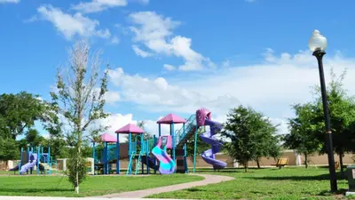 a playground with a slide in a park at Coral Cay - 4 Bed 3 Baths Townhome in Kissimmee