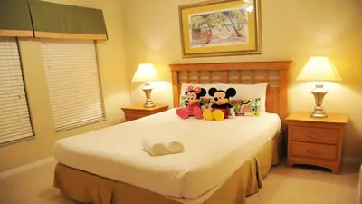 a bedroom with two stuffed animals sitting on a bed at Coral Cay - 4 Bed 3 Baths Townhome in Kissimmee
