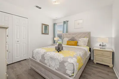 a small bedroom with a bed and a night stand at #196-Fantastic 6 bed villa with own private pool and spa with no rear neighbors in Orlando