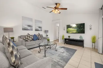 a living room with a couch and a ceiling fan at #196-Fantastic 6 bed villa with own private pool and spa with no rear neighbors in Orlando