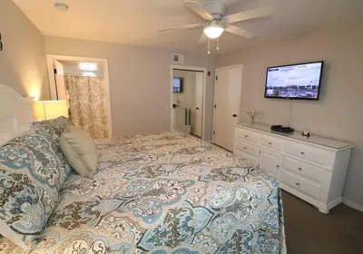 a bedroom with a bed and a ceiling fan at LOVE AT FIRST SIGHT! NEW Disney Home, Sleeps 6, Pool, Patio, NO Steps, LOW Rates! in Kissimmee