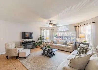 a living room with a couch and a tv at LOVE AT FIRST SIGHT! NEW Disney Home, Sleeps 6, Pool, Patio, NO Steps, LOW Rates! in Kissimmee