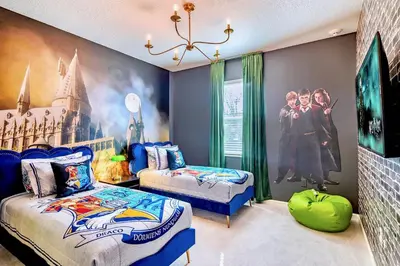 a room with two beds and a mural on the wall at 8BR Resort Home with Games Room and BBQ in Kissimmee