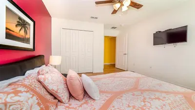 a bedroom with a bed and a flat screen tv at Shvcc2 - Crystal Cove #2 - 7 Bed 45 Baths Villa in Kissimmee