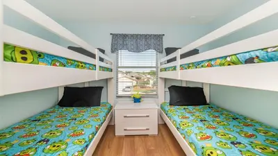 a bedroom with two bunk beds and a window at Shvcc2 - Crystal Cove #2 - 7 Bed 45 Baths Villa in Kissimmee