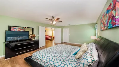 a living room with a bed and a flat screen tv at Shvcc2 - Crystal Cove #2 - 7 Bed 45 Baths Villa in Kissimmee