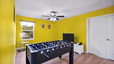 a room with yellow walls and a ceiling fan at Shvcc1 - Crystal Cove #1 - 7 Bed 45 Baths Villa in Kissimmee
