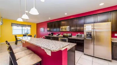 a kitchen with red and yellow walls at Shvcc1 - Crystal Cove #1 - 7 Bed 45 Baths Villa in Kissimmee