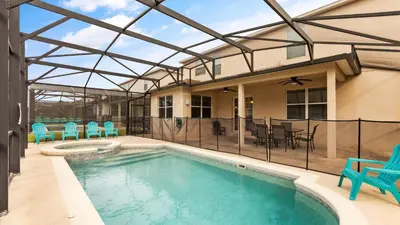 a swimming pool with blue chairs and a house at Shvcc1 - Crystal Cove #1 - 7 Bed 45 Baths Villa in Kissimmee