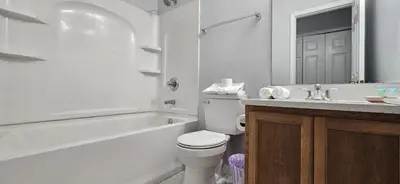 a white bathroom with a toilet and a sink at Shvpc3 - Paradise Cay #3 - 3 Bed 25 Baths Townhome in Kissimmee