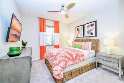 a bedroom with a bed and a dresser and a window at 15BR Mansion Home with Pool & Hot Tub-near Disney in Kissimmee