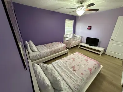 a room with two beds and a crib in it at Paradise Palms Resort - 6 Bed 5 Baths Villa in Kissimmee