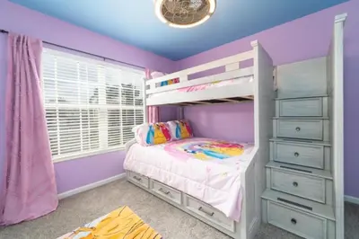 a childs bedroom with purple walls and a bunk bed at Callaghan Cantina home in Orlando