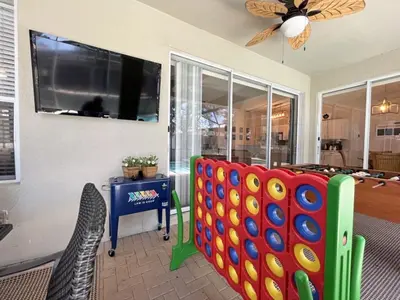 a living room with two chairs and a flat screen tv at Callaghan Cantina home in Orlando
