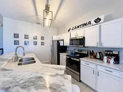 a kitchen with white cabinets and a counter top at Callaghan Cantina home in Orlando