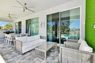 a living room with a couch and a table at Elite Home Near Disney With Theater Room, Game Room And Private Pool With Water Park Access At Encore Resorts Reunion - 200Au in Kissimmee