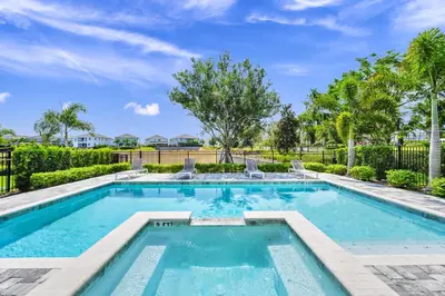 a swimming pool with trees and a fence at Elite Home Near Disney With Theater Room, Game Room And Private Pool With Water Park Access At Encore Resorts Reunion - 200Au in Kissimmee