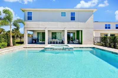 a house with a swimming pool in front of a house at Elite Home Near Disney With Theater Room, Game Room And Private Pool With Water Park Access At Encore Resorts Reunion - 200Au in Kissimmee