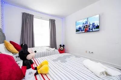 a bedroom with a stuffed animal on the bed at Your Orlando home 15 min to Disney - KGG01 in Kissimmee