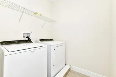 a white washer and dryer in a white room at Lovely Home Near Disney With Private Pool, Water Park & Resort Access At Encore Resort Reunion - 7423Mr in Kissimmee
