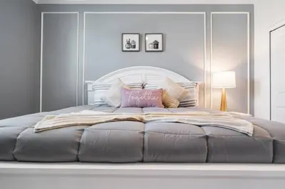 a bedroom with a large bed with a white headboard at Luxury 9BR Villa @ Storey Lake Resort Near Disney in Kissimmee