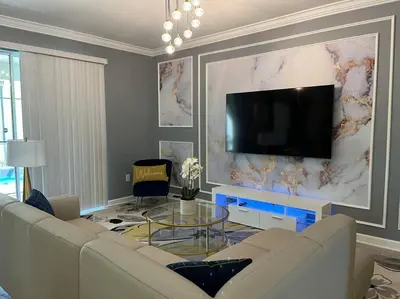 a living room with a couch and a flat screen tv at Luxury 9BR Villa @ Storey Lake Resort Near Disney in Kissimmee