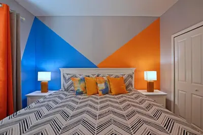 a bedroom with a large bed with two lamps at Amazing 6BR Villa @ Storey Lake Resort Near Disney in Kissimmee