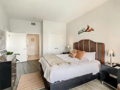 a bedroom with a large bed with a striped headboard at Pet friendly in Orlando area near Disney and ESPN Center in Orlando