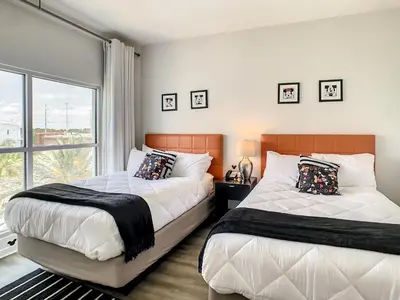 a bedroom with two beds and a large window at Pet friendly in Orlando area near Disney and ESPN Center in Orlando