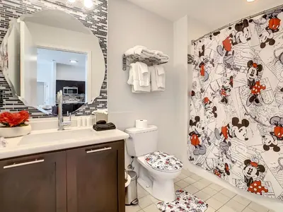 a bathroom with a toilet and a shower curtain at Pet friendly in Orlando area near Disney and ESPN Center in Orlando