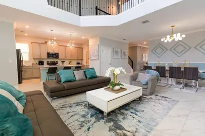 a living room with a couch and a table at Modern Adventure Home near to Disney in Kissimmee