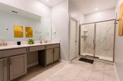 a bathroom with two sinks and a shower at Modern Adventure Home near to Disney in Kissimmee