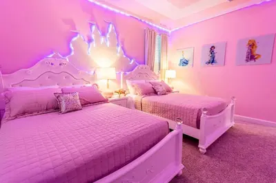 two beds in a room with pink walls at Modern Adventure Home near to Disney in Kissimmee