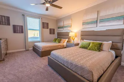 a bedroom with two beds and a ceiling fan at Modern Adventure Home near to Disney in Kissimmee