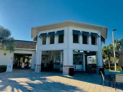 a building with a table and chairs in front of it at Magical Themed Home - Disney 15 min in Kissimmee