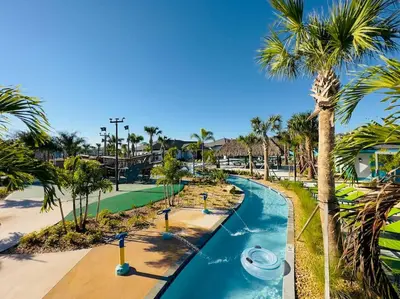 an aerial view of a pool at a resort with palm trees at Magical Themed Home - Disney 15 min in Kissimmee
