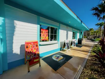 a blue and white building with a store at Magical Themed Home - Disney 15 min in Kissimmee