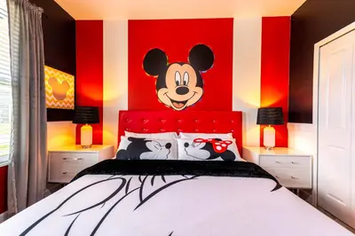 a bedroom with a bed with a mickey mouse headboard at 6BR Disney Oasis with Pool, Game Room and Resort in Kissimmee