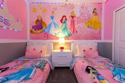 two beds in a girls bedroom with a disney princess mural at 6BR Disney Oasis with Pool, Game Room and Resort in Kissimmee